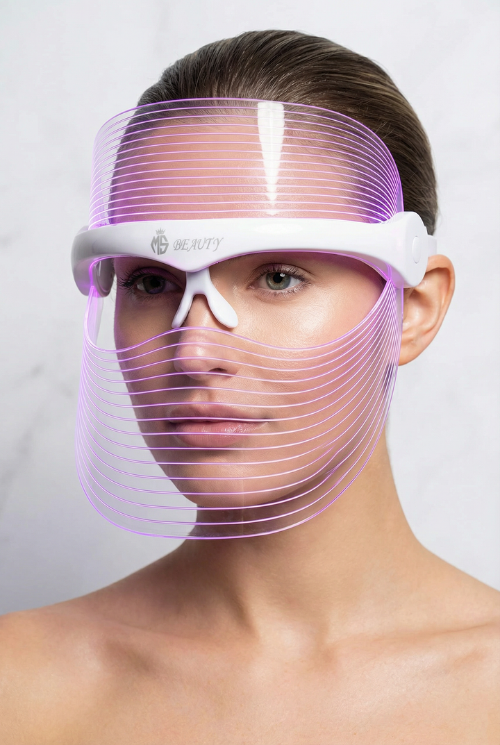 Woman wearing 7-color LED light therapy face mask in purple mode