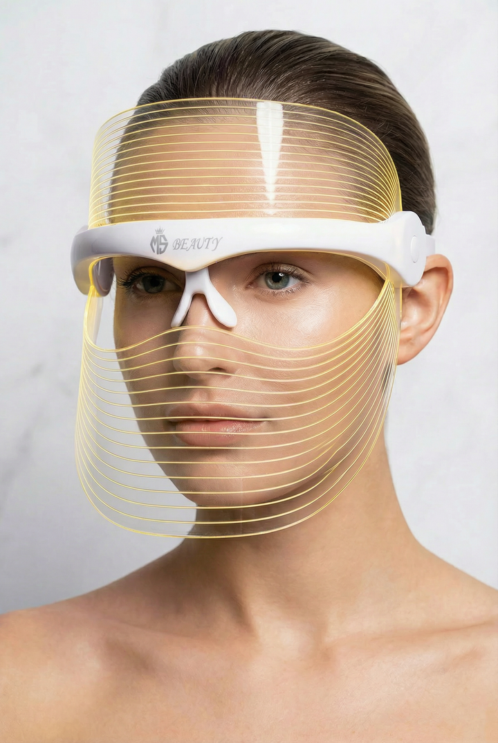 Woman wearing 7-color LED light therapy face mask in yellow mode