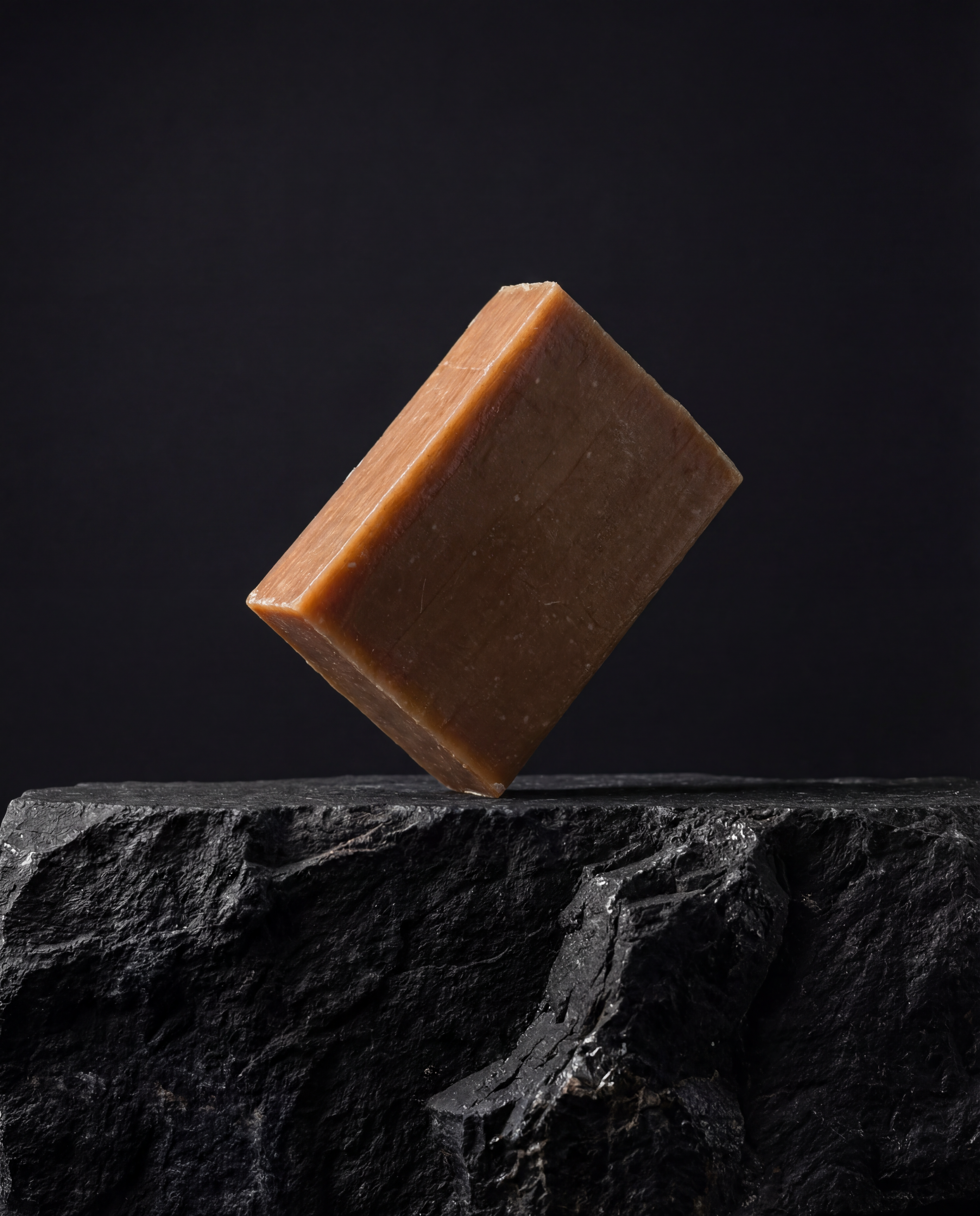 Handmade Moroccan argan oil soap bar resting on its edge against a pale background