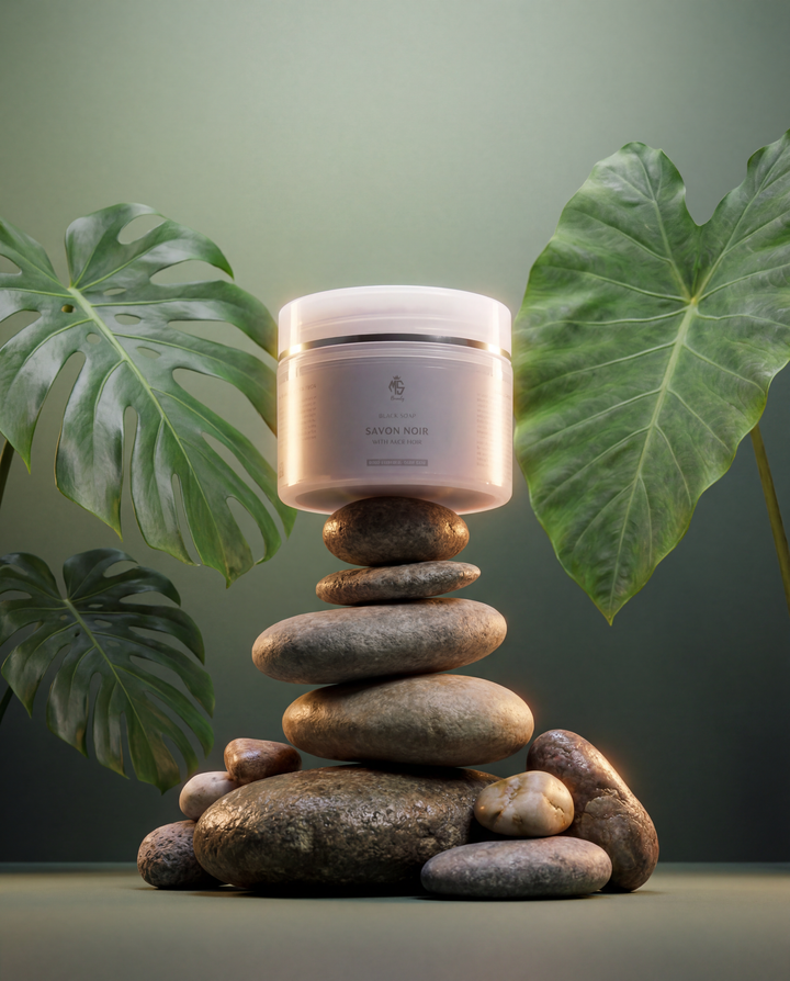 Jar of cream on stacked stones with green leaves in the background