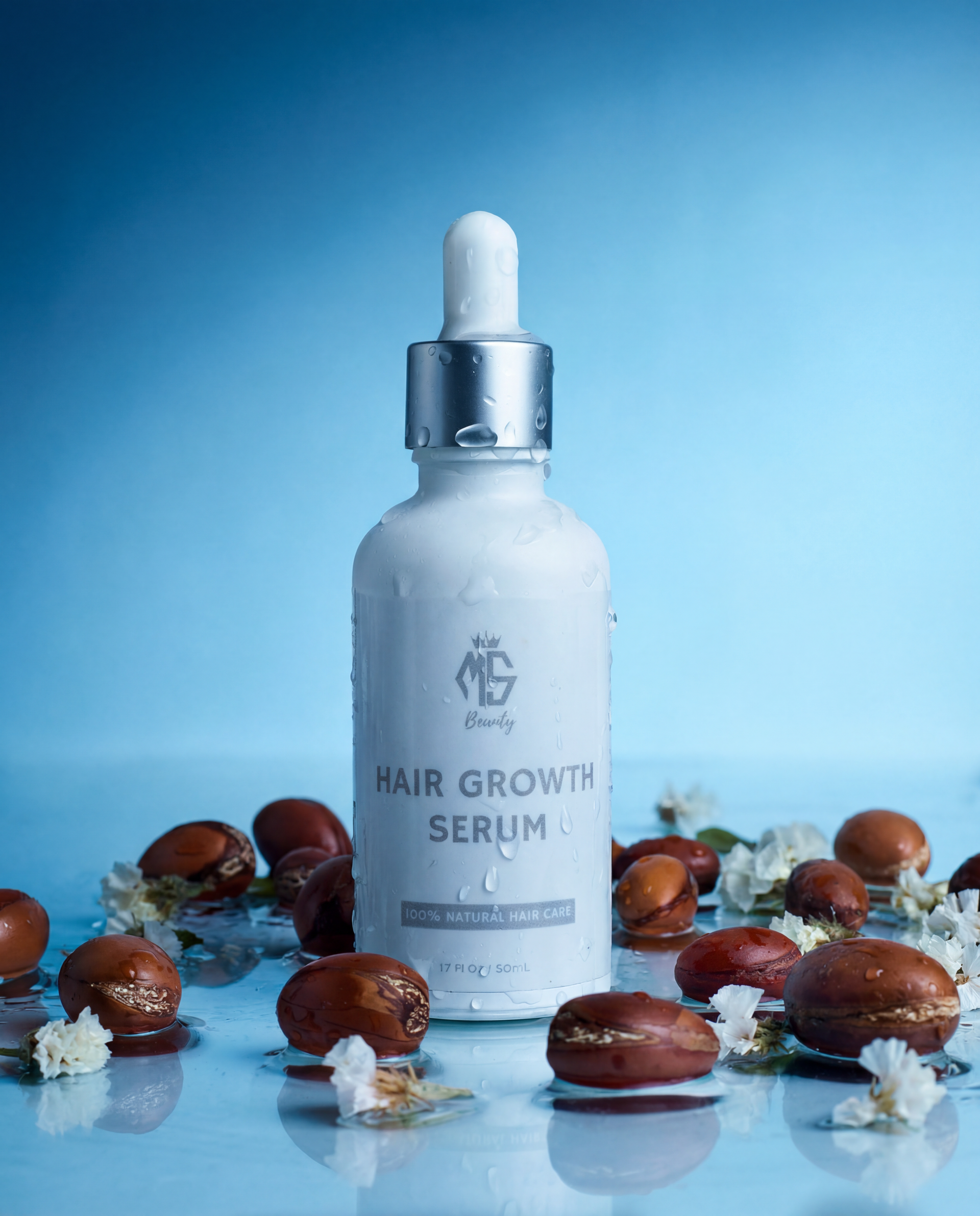 Hair growth serum bottle with dropper on a blue background