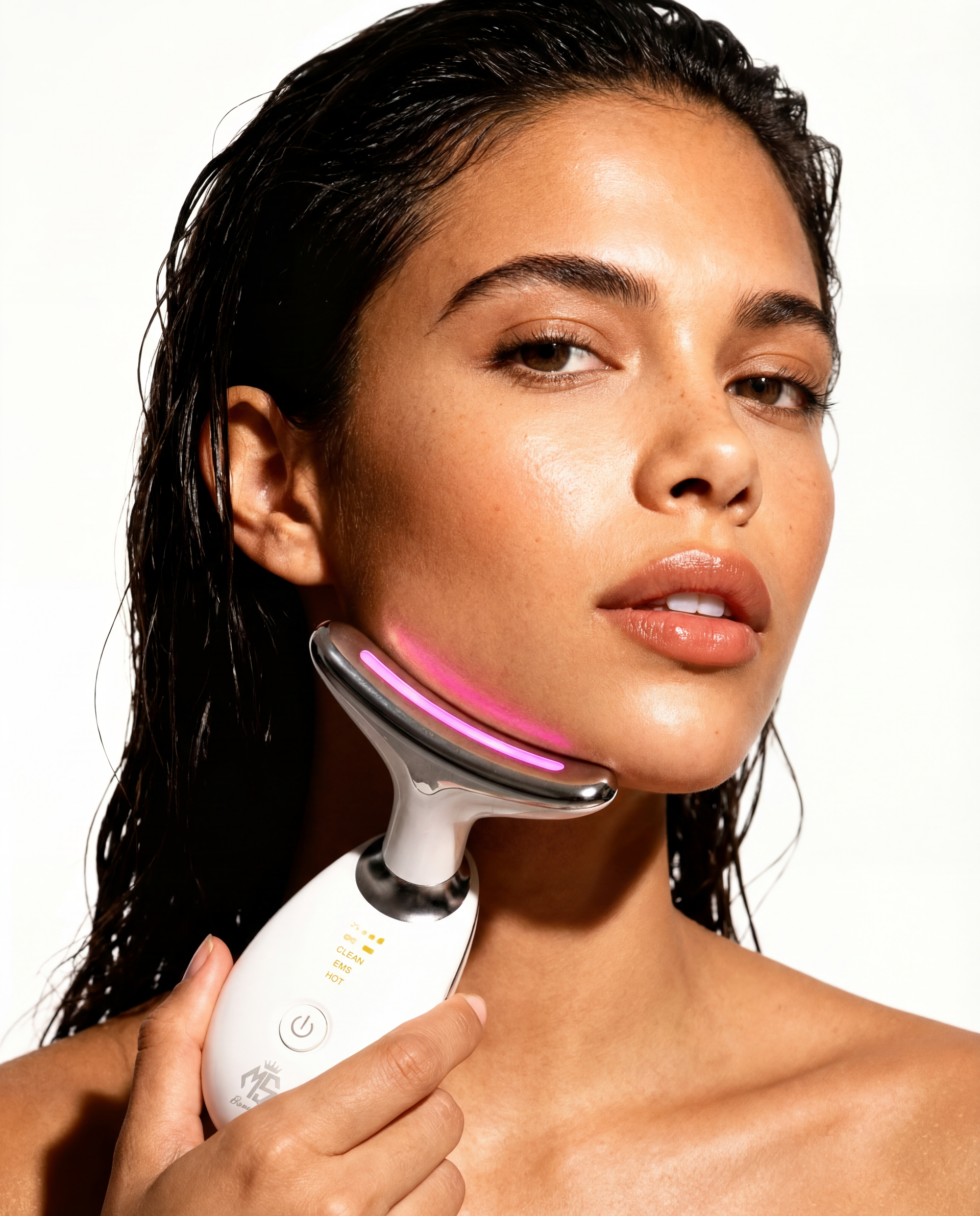 Woman using LED neck lifting massager on jawline and neck