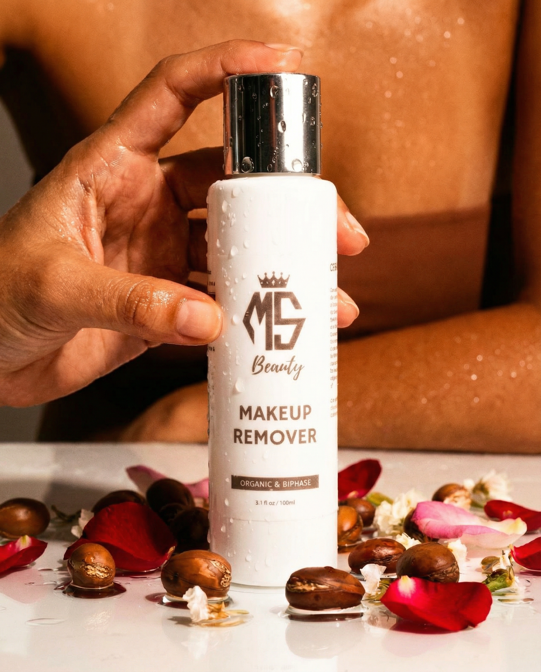 Hand holding a bottle of Makeup Remover with decorative elements in the background