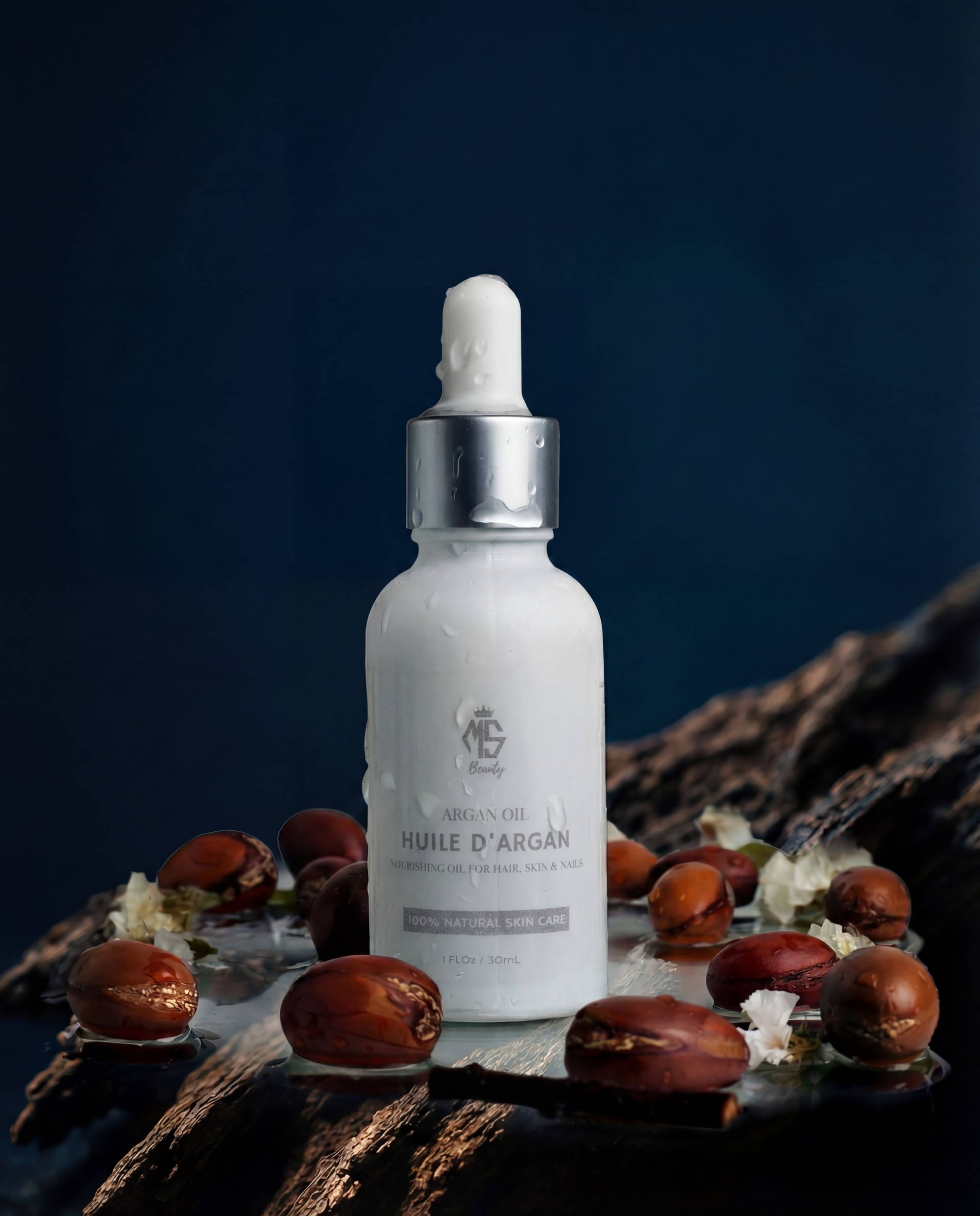 Skincare serum bottle with argan seeds on a dark background